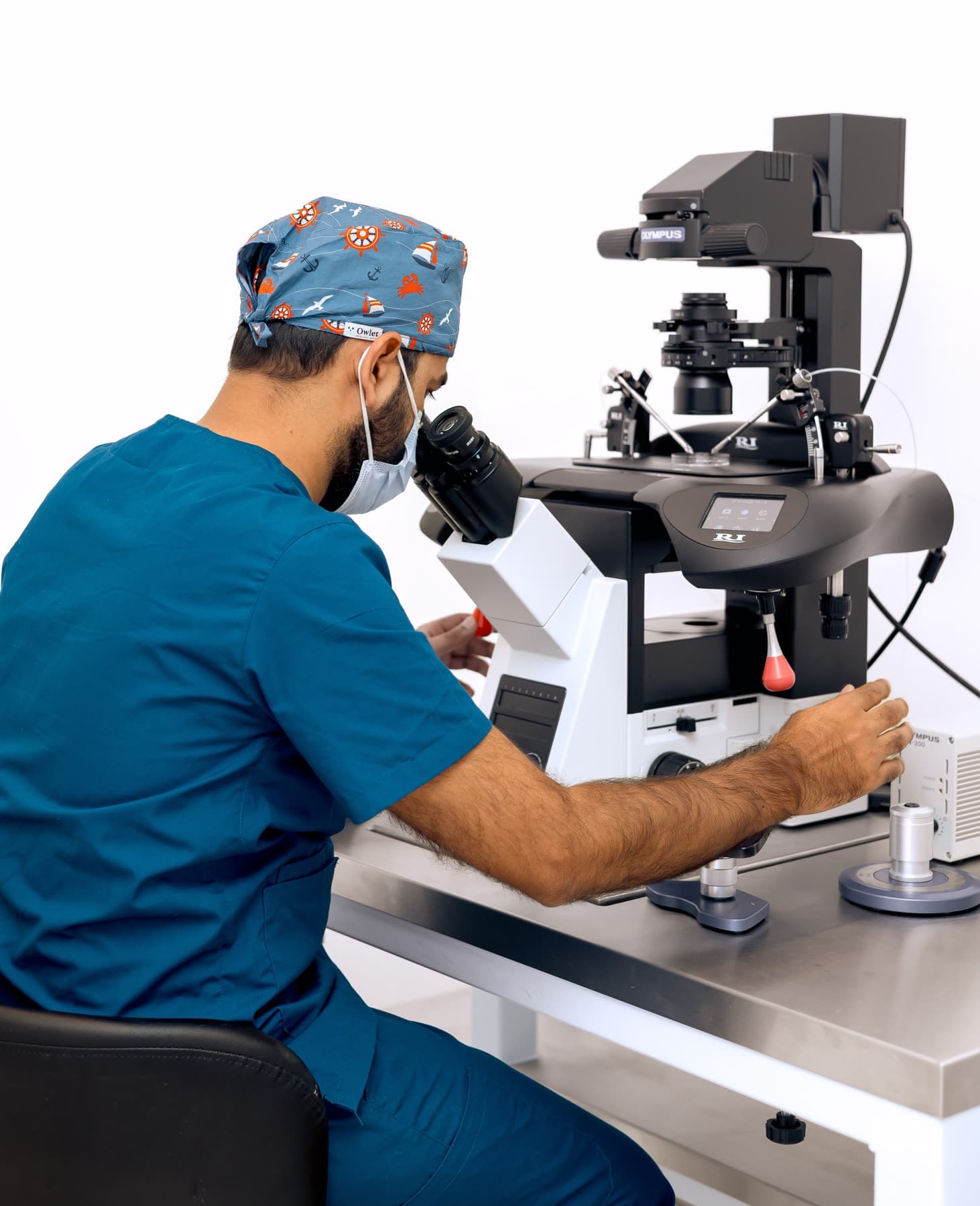 Embryologist preparing samples at the laboratory microscope at Hope IVF International