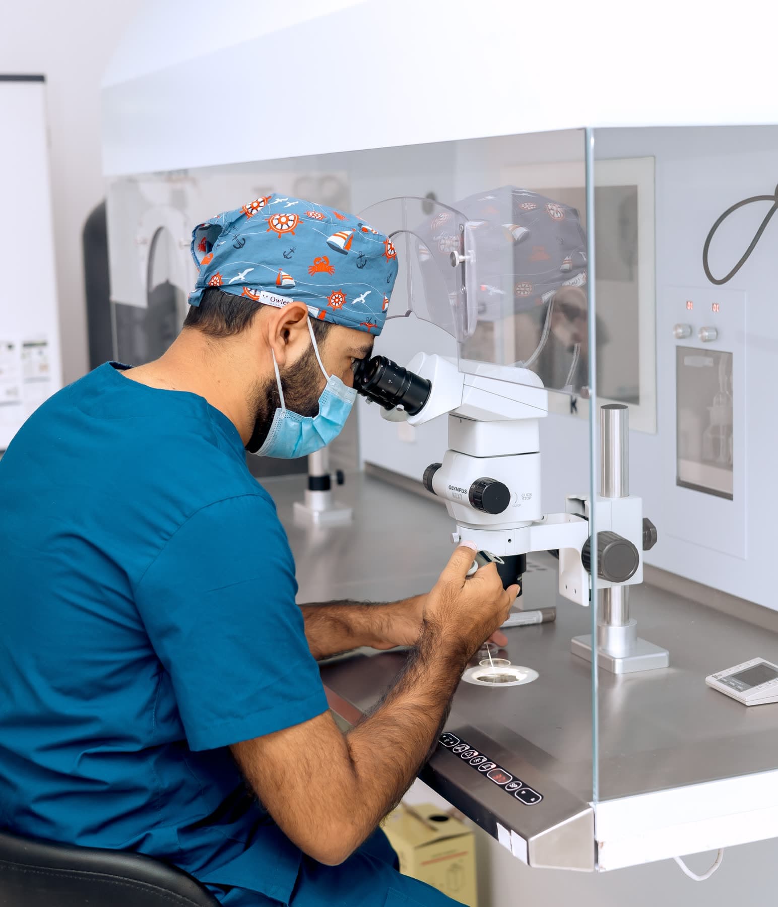 Embryologist working at a laboratory workstation at Hope IVF International